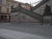 there is an old stairway and street light near building windows with stone steps on it