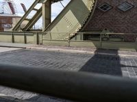 an old bridge has a clock and other things in the background from the pavement on the road