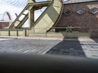 an old bridge has a clock and other things in the background from the pavement on the road