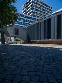 the building has several different angles on it, in varying colors and shapes with brick and concrete floors