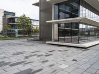 an empty patio that has a brick design in it and glass walls on the side