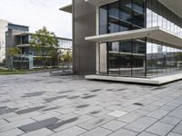 an empty patio that has a brick design in it and glass walls on the side