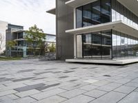 an empty patio that has a brick design in it and glass walls on the side