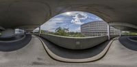 a view of a city from under a bridge with traffic underneath the bridge is shown through the hole