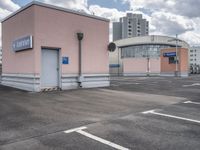 the building has an entrance and parking spot near by a sign on the parking lot