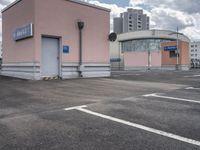 the building has an entrance and parking spot near by a sign on the parking lot