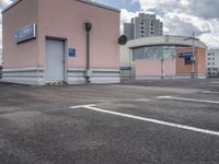 the building has an entrance and parking spot near by a sign on the parking lot