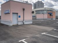 the building has an entrance and parking spot near by a sign on the parking lot