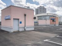 the building has an entrance and parking spot near by a sign on the parking lot