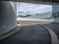 a car is driving on the highway through an underground parking garage area in a city