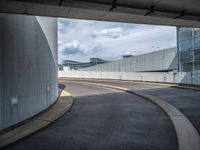 a car is driving on the highway through an underground parking garage area in a city