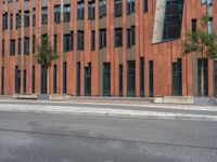 a building with some concrete blocks and a sidewalk in front of it and a sign for the parking area