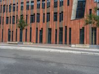 a building with some concrete blocks and a sidewalk in front of it and a sign for the parking area