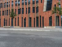 a building with some concrete blocks and a sidewalk in front of it and a sign for the parking area