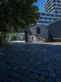 the building has several different angles on it, in varying colors and shapes with brick and concrete floors