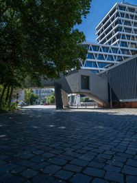 the building has several different angles on it, in varying colors and shapes with brick and concrete floors