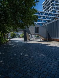 the building has several different angles on it, in varying colors and shapes with brick and concrete floors