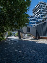 the building has several different angles on it, in varying colors and shapes with brick and concrete floors