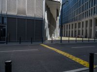 the empty street with bicycles parked in front of the buildings has a sign that says the library on it