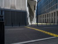 the empty street with bicycles parked in front of the buildings has a sign that says the library on it