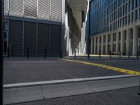 the empty street with bicycles parked in front of the buildings has a sign that says the library on it