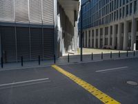 the empty street with bicycles parked in front of the buildings has a sign that says the library on it