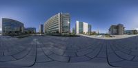 a panoramic view of buildings and gardens that look like they are taken with a fish eye lens