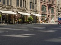 pedestrians and cars are driving down the street in a european city square at sunset - style