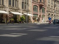 pedestrians and cars are driving down the street in a european city square at sunset - style