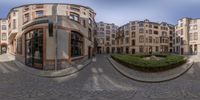 a wide shot of a circular building and street in europe with a few people outside