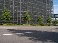 the exterior of a large office building with a lot of windows on each side of the building