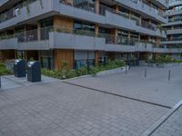 a courtyard of an apartment building with parking meters next to the walkways, and several balconies