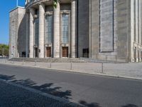 an entrance of a building with large columns and doors that spell out the word voltege