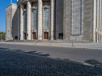 an entrance of a building with large columns and doors that spell out the word voltege