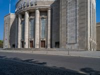 an entrance of a building with large columns and doors that spell out the word voltege