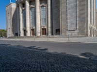 an entrance of a building with large columns and doors that spell out the word voltege