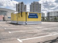 there is a parking lot with a large building in the background on a sunny day