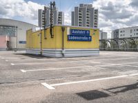 there is a parking lot with a large building in the background on a sunny day