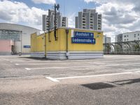 there is a parking lot with a large building in the background on a sunny day