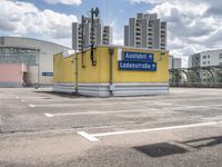 there is a parking lot with a large building in the background on a sunny day