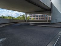 a car is driving on the highway through an underground parking garage area in a city