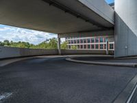 a car is driving on the highway through an underground parking garage area in a city