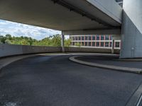 a car is driving on the highway through an underground parking garage area in a city