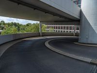 a car is driving on the highway through an underground parking garage area in a city