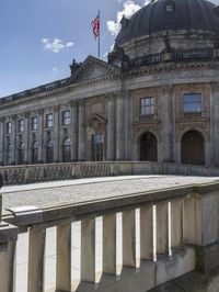 the building is ornately constructed and has a large dome on top with many windows