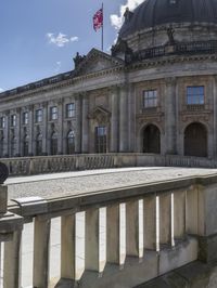 the building is ornately constructed and has a large dome on top with many windows