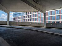 a car is driving on the highway through an underground parking garage area in a city