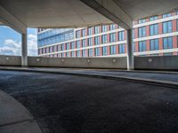 a car is driving on the highway through an underground parking garage area in a city