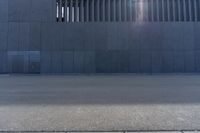 a person wearing a face mask walking across an empty street with a skateboard in the foreground