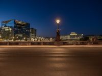 the city skyline is at night from the street level with traffic and pedestrians walking on it